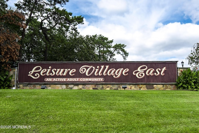 community sign featuring a lawn