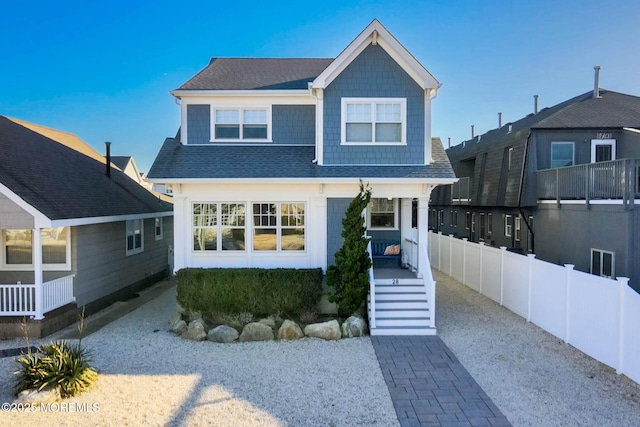 view of front facade featuring fence