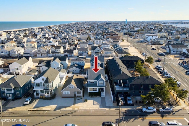 drone / aerial view with a residential view and a water view