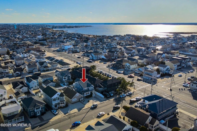 drone / aerial view with a water view and a residential view