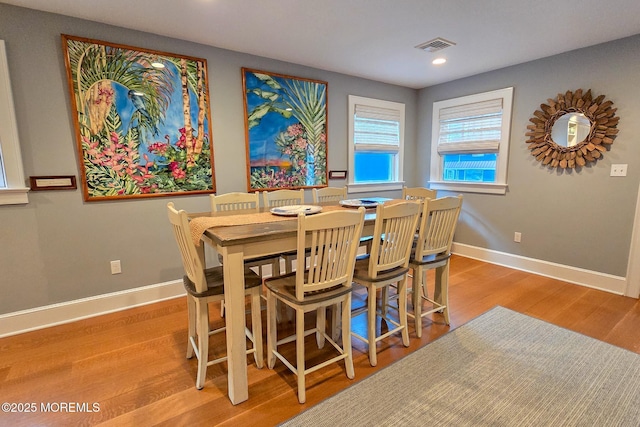 dining area with visible vents, recessed lighting, wood finished floors, and baseboards