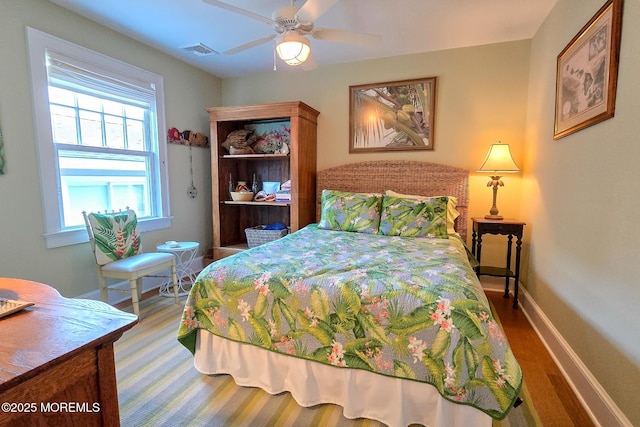 bedroom with visible vents, baseboards, and ceiling fan