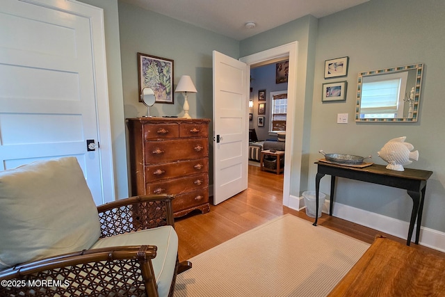 living area with wood finished floors and baseboards