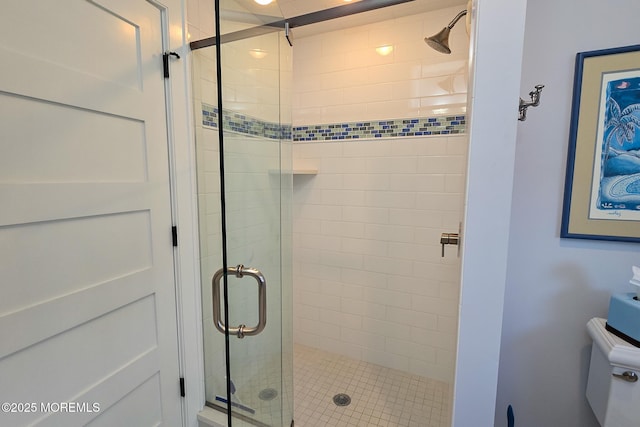 full bathroom featuring toilet and a stall shower