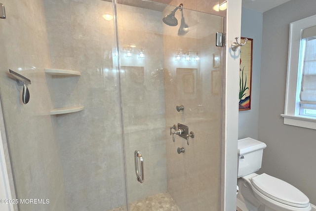 full bath with a shower stall and toilet