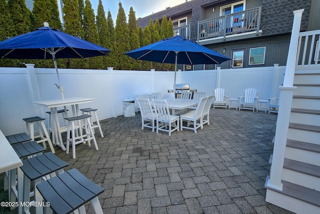 view of patio / terrace featuring outdoor dining area and fence