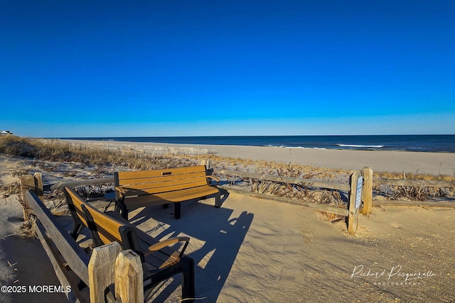 surrounding community featuring a water view and a view of the beach