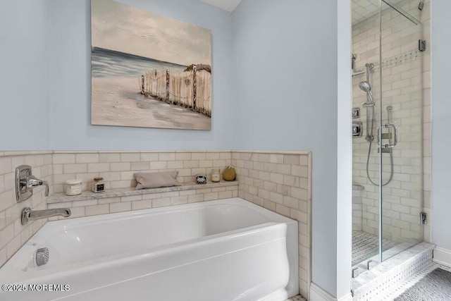 full bath featuring a stall shower and a garden tub