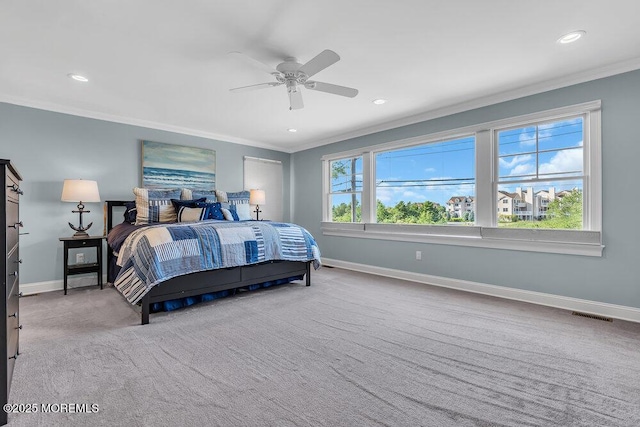 carpeted bedroom with visible vents, recessed lighting, baseboards, and ornamental molding