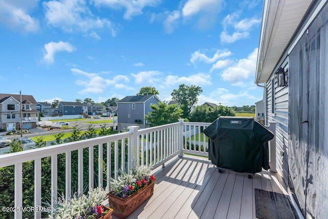 deck featuring a residential view and a grill