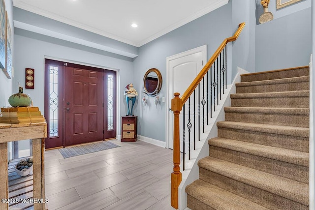 entryway featuring recessed lighting, stairway, baseboards, and crown molding