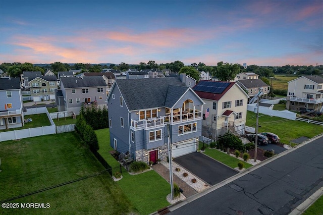 aerial view at dusk featuring a residential view