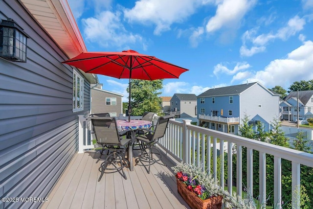 deck with a residential view and outdoor dining space