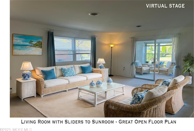 carpeted living area featuring visible vents and a healthy amount of sunlight