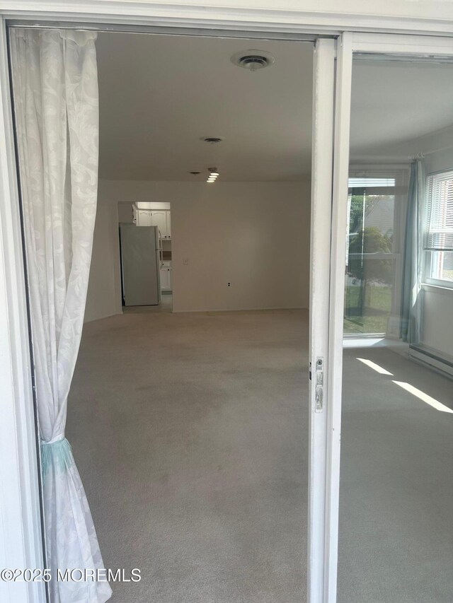 garage with visible vents and freestanding refrigerator
