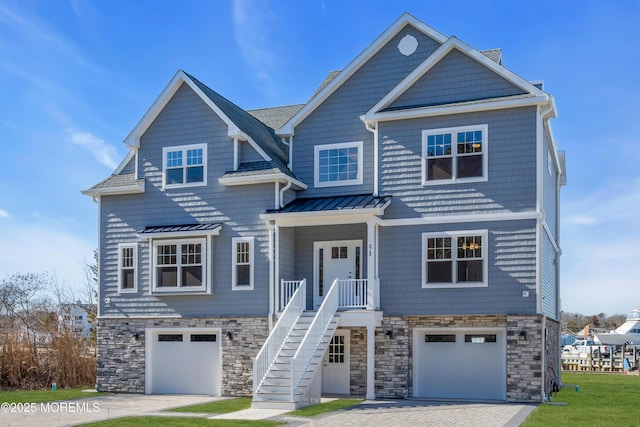 view of front of house with stone siding, metal roof, stairs, and a standing seam roof