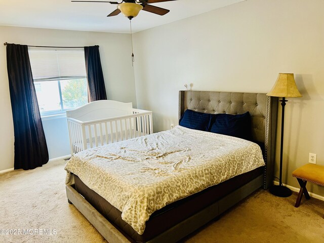bedroom with carpet flooring, a ceiling fan, and baseboards