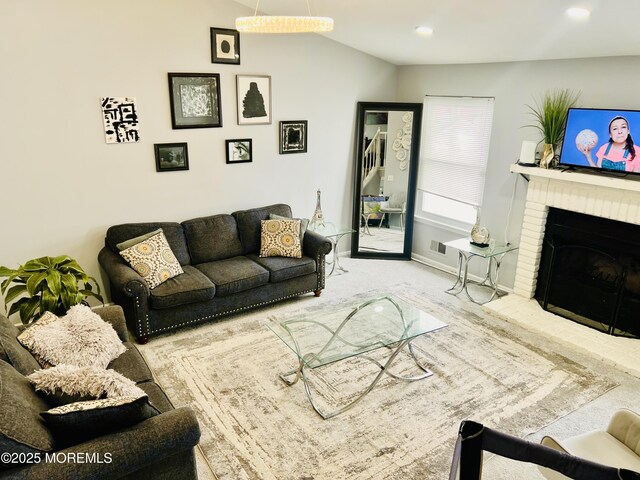 living room with recessed lighting, baseboards, carpet, lofted ceiling, and a brick fireplace