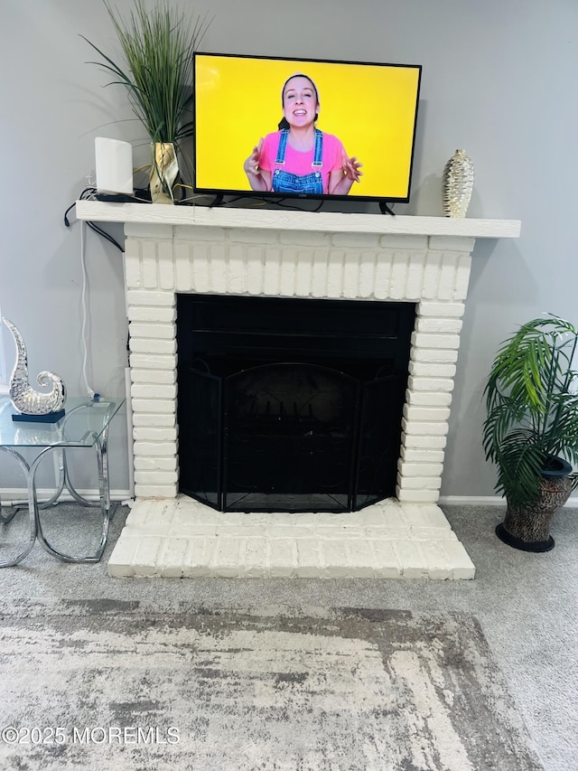 interior details with a fireplace, baseboards, and carpet floors