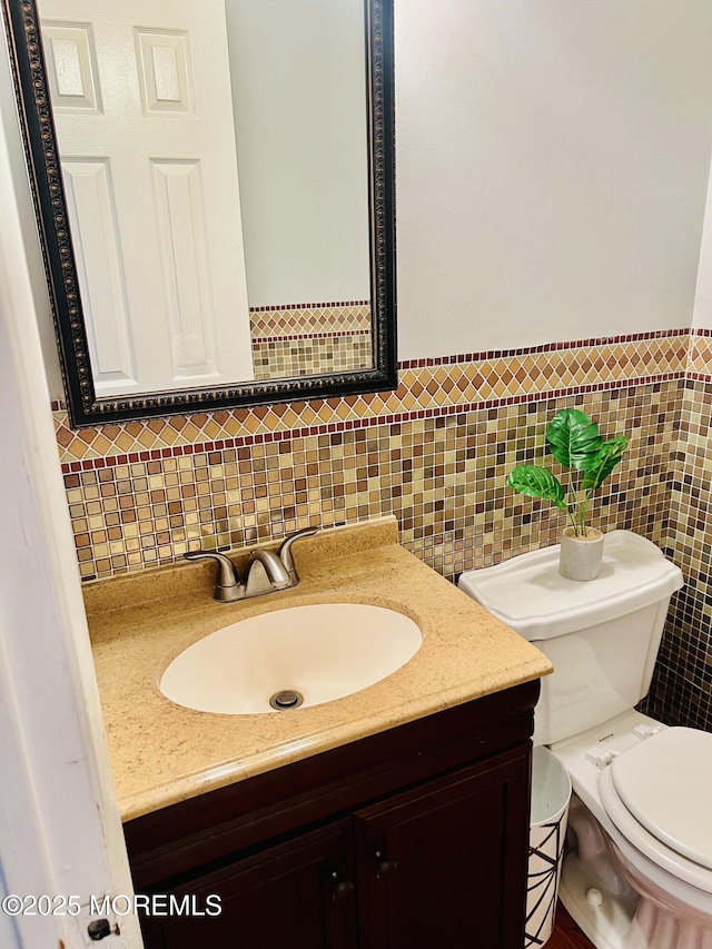 bathroom featuring toilet and vanity