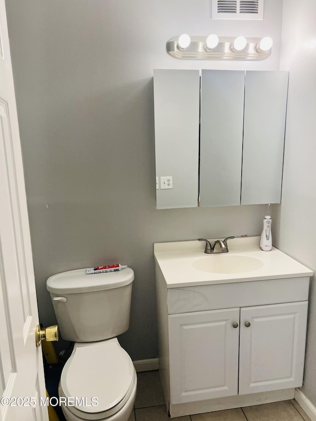 bathroom featuring tile patterned floors, visible vents, toilet, baseboards, and vanity