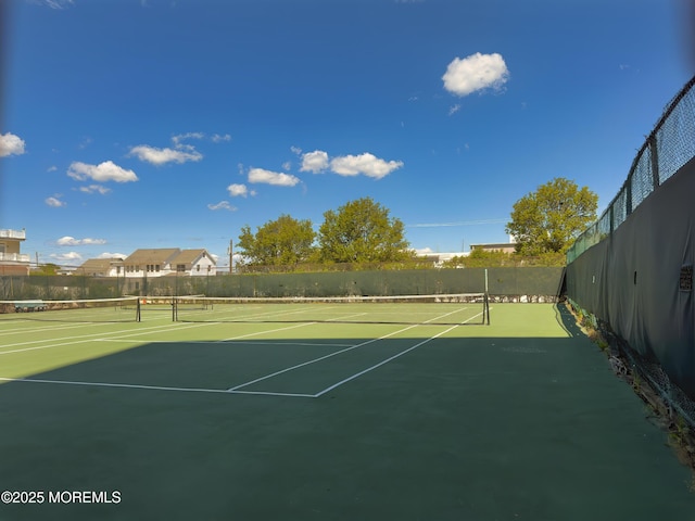 view of sport court featuring fence