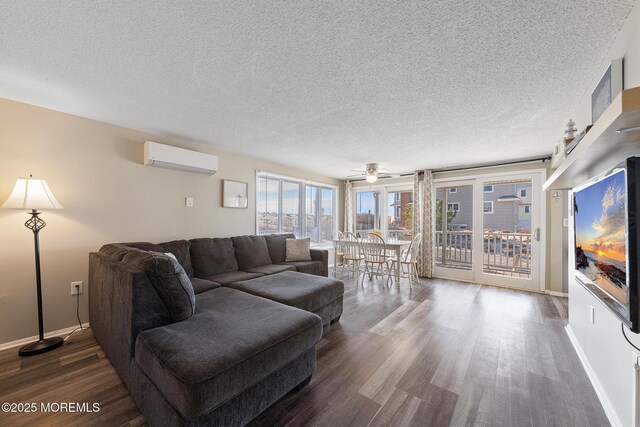 5909 Ocean Blvd, Long Beach Twp, NJ 08008 - living room featuring dark wood finished floors, an AC wall unit, baseboards, and a textured ceiling