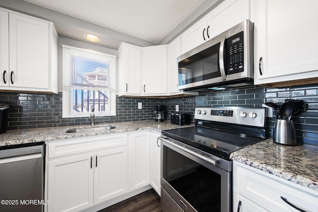 5909 Ocean Blvd, Long Beach Twp, NJ 08008 - kitchen with white cabinets, appliances with stainless steel finishes, a textured ceiling, and a sink