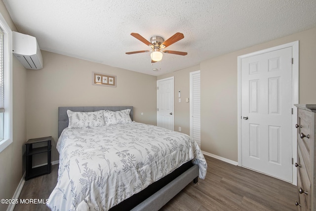 5909 Ocean Blvd, Long Beach Twp, NJ 08008 - bedroom with wood finished floors, baseboards, a wall mounted air conditioner, and a textured ceiling