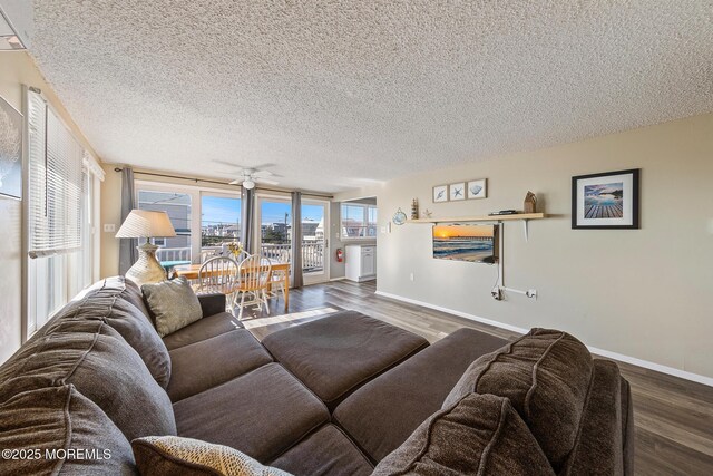 5909 Ocean Blvd, Long Beach Twp, NJ 08008 - living room featuring a textured ceiling, a ceiling fan, baseboards, and wood finished floors