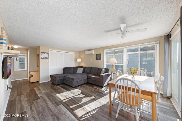 5909 Ocean Blvd, Long Beach Twp, NJ 08008 - living area with a textured ceiling, a wall mounted air conditioner, baseboards, and wood finished floors
