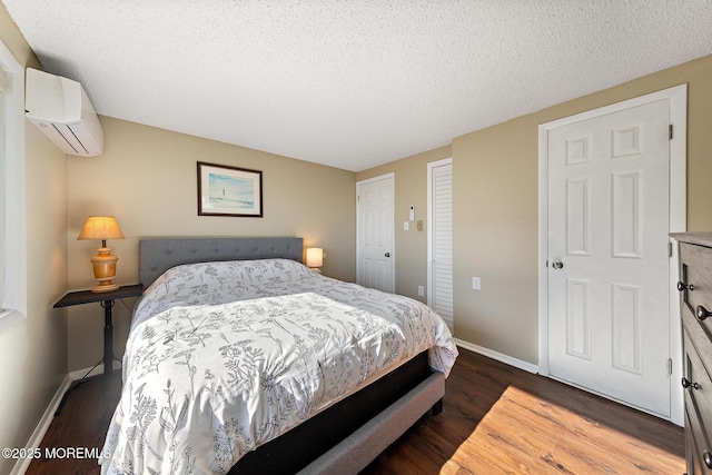 5909 Ocean Blvd, Long Beach Twp, NJ 08008 - bedroom with a wall mounted air conditioner, baseboards, a textured ceiling, and wood finished floors