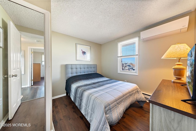 5909 Ocean Blvd, Long Beach Twp, NJ 08008 - bedroom with a textured ceiling, a baseboard heating unit, a wall unit AC, and wood finished floors
