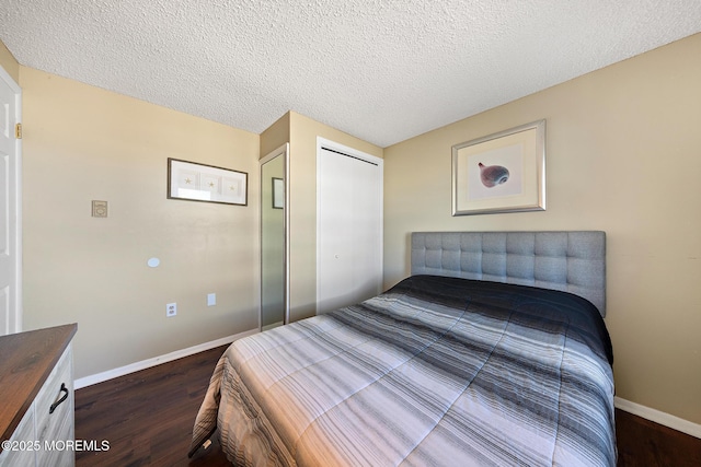 5909 Ocean Blvd, Long Beach Twp, NJ 08008 - bedroom with a closet, a textured ceiling, dark wood-type flooring, and baseboards