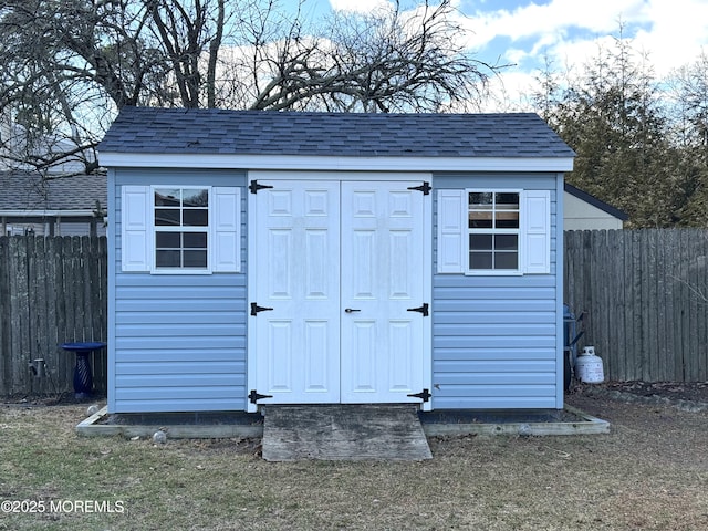 view of shed featuring fence