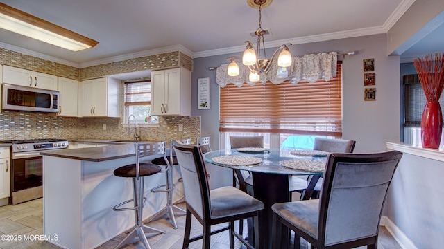 kitchen with crown molding, stainless steel appliances, tasteful backsplash, white cabinets, and a sink