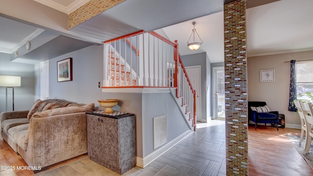 interior space featuring visible vents, crown molding, stairway, and baseboards