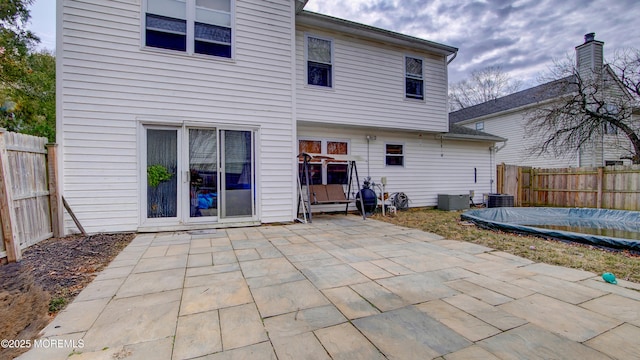 back of house featuring a patio area and fence