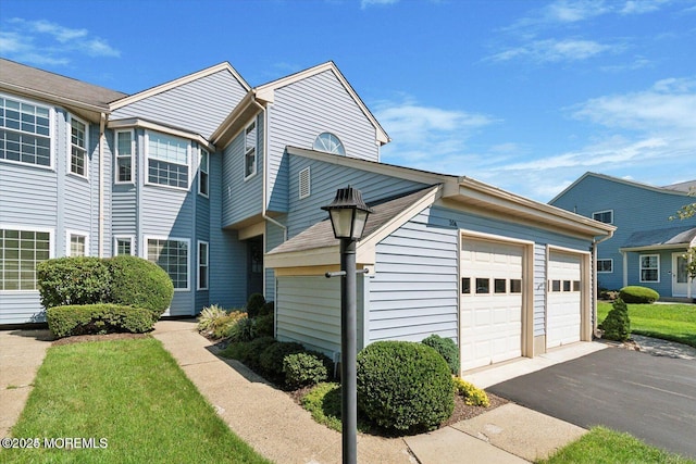 view of property exterior featuring driveway and an attached garage