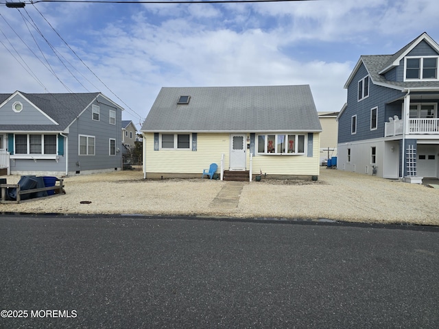 view of front of property featuring entry steps and a shingled roof