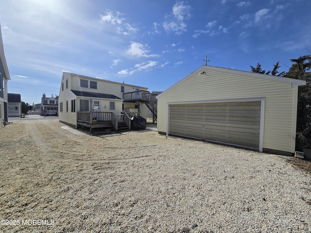 exterior space with a garage, a deck, and an outdoor structure