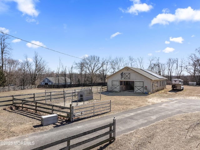 view of horse barn featuring a rural view