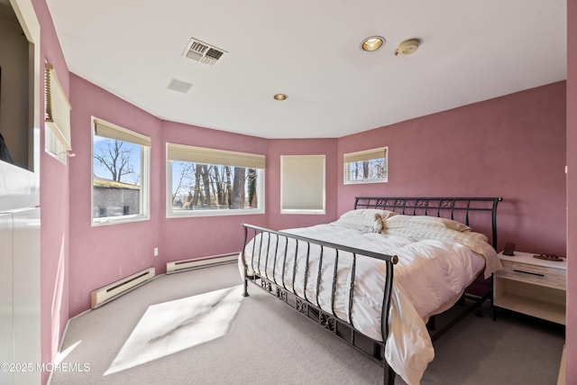 bedroom with a baseboard heating unit, recessed lighting, visible vents, and carpet flooring