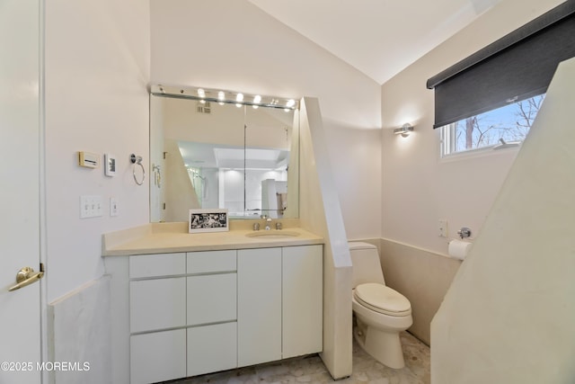 bathroom with vaulted ceiling, visible vents, vanity, and toilet