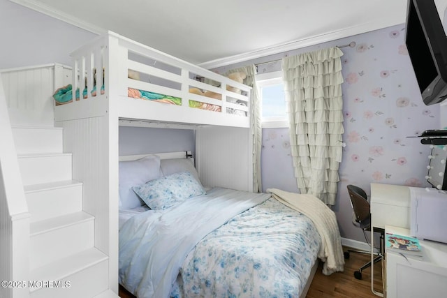 bedroom featuring wallpapered walls and wood finished floors