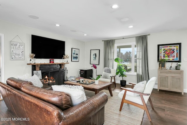 living room featuring a brick fireplace, recessed lighting, wood finished floors, and baseboards