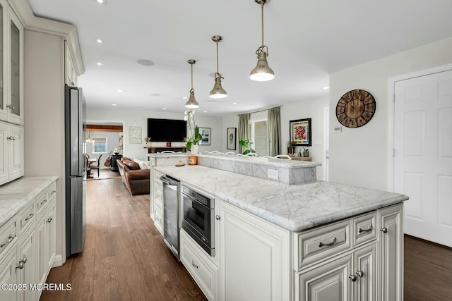 kitchen featuring dark wood-style flooring, built in microwave, freestanding refrigerator, glass insert cabinets, and a center island