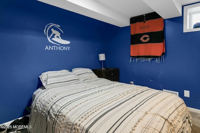 bedroom featuring visible vents, baseboards, and carpet flooring