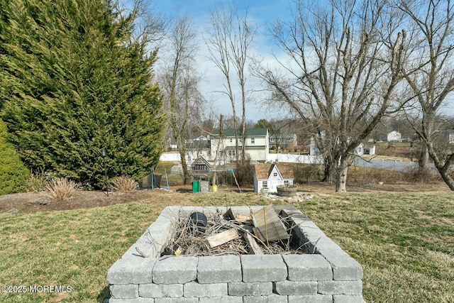 view of yard with a fire pit