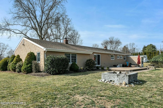 rear view of property with a patio, a lawn, and a chimney